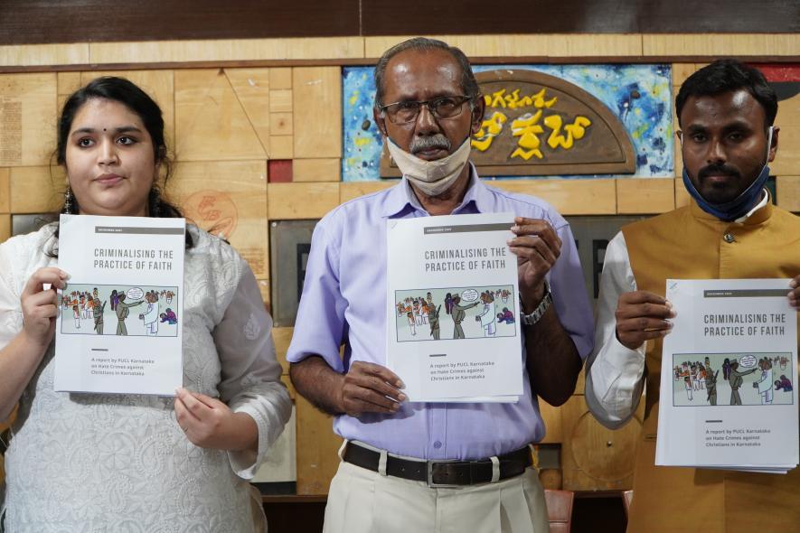 Advocate Manavi of ALF, YJ Rajendra of PUCL and Pastor Lucas present the report.